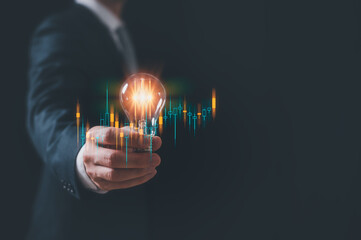 concept of create new ideas, a man handle light bulb and typing on keyboard..planning and strategy, Stock market, Business growth, progress or success concept. 