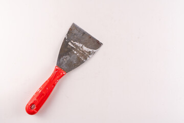 Selective focus top view of steel trowel scraper or construction spatula isolated on white...