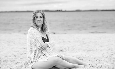 Plus size European blonde woman in stylish romantic women's summer clothes at beach. Concept of sizes, happy nice natural beautiful lady 