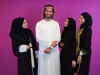 Group portrait of young muslim people arabian man with three muslim women in fashionable dress with...