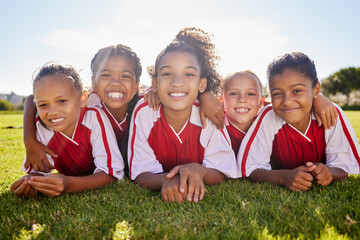 Girl, soccer group portrait and lying with smile, team building happiness or solidarity to relax at...