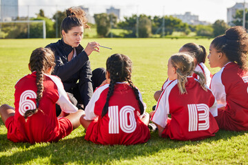 Coaching, exercise or coach with children for soccer strategy, training and team goals in Canada. Team building, teamwork and woman planning group of girl on football field for game, match or workout