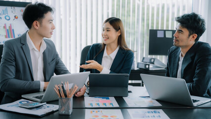 Group of Young Asian business team creative businesspeople coworker in office. Meeting Presentation for analysis graph company financial. People Work in Business Office.