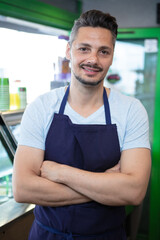 handsome guy in apron is selling ice cream