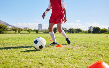 Soccer child, field and training for fitness, sports and balance for control, speed and strong body development. Cropped football player kid, fast dribbling and exercise feet on grass in Cape Town