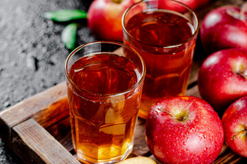 Fresh homemade apple juice. On a black background.