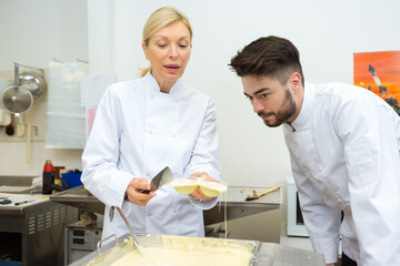 portrait of workers melting white chocolate