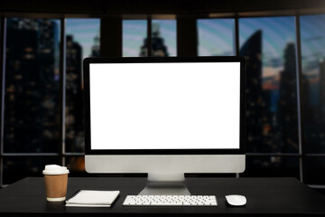 Fototapeta premium Workspace computer putting on wood working desk and surrounded by coffee cup, clipboard, potted plant, stack of smartphone, tablet, and keyboard Orderly office. workspace concept..
