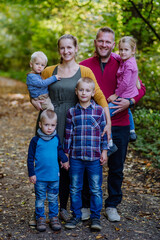Portrait of big happy family with kids in a forest.