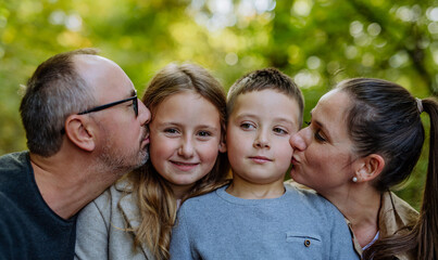 Fototapeta premium Portrait of happy family with kids in a forest.