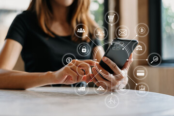 Businesswoman hand working digital marketing media in virtual screen with mobile phone and modern compute with VR icon diagram at office in morning light .