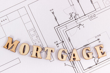 Fototapeta na wymiar Inscription mortgage on electrical drawing, buying or building house concept