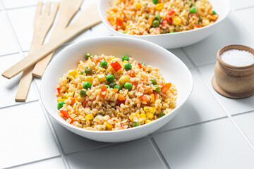 Bulgur with vegetables in a white plate close-up
