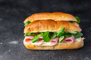 sandwich ham french milk buns, cheese, lettuce green leaves fresh meal food snack on the table copy space food background rustic top view