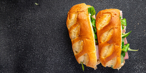 sandwich ham french milk buns, cheese, lettuce green leaves fresh meal food snack on the table copy space food background rustic top view