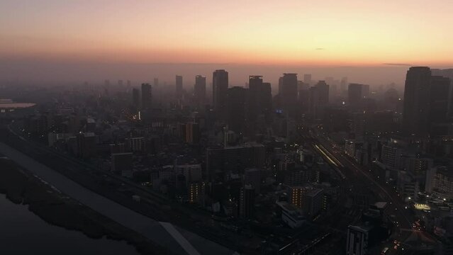 Sunrise through haze and mist over modern high rise office buildings
