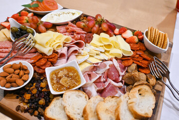 Italian antipasti panoramic banner with a wineglass and prosciutto di Parma ham, salami, gorgonzola and olives and variety assorted cheese.