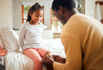 Black family, father and knee bandage for girl after accident or injury. First aid, healthcare and man apply bandaid or plaster on leg of hurt or injured child for wellness and recovery in bedroom.