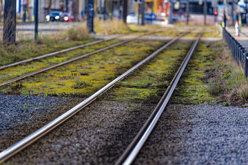 Fototapeta premium Tramway with tracks of tram line four and modern foot bridge in the background at City of Zürich on a blue cloudy winter day. Photo taken January 2nd, 2023, Zurich, Switzerland.