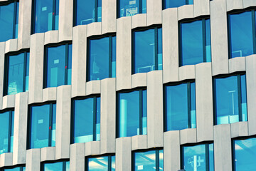 Close-up of pattern of modern facade of office building at City of Zürich on a blue cloudy day....
