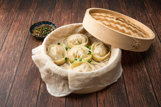 Delicious homemade Korean kimchi dumplings in a bamboo steamer.