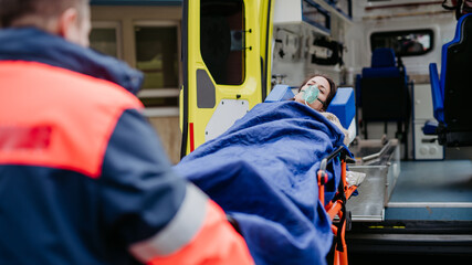 Rescuer taking care of patient, preparing her for transport.