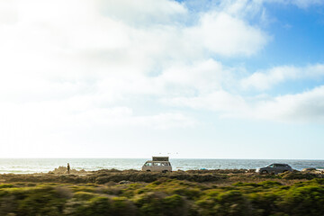 A Van Drives Along the Coast of Carmel, California as the Sun begins to Set