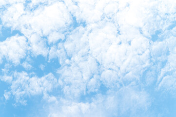 Nature background from white clouds in sunny day. Beautiful white fluffy clouds in blue sky.