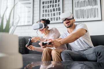 Virtual reality, gaming and metaverse with a couple playing video games in their home together for fun or enjoyment. VR, game and 3d ai with a man and woman gamer bonding in a house living room