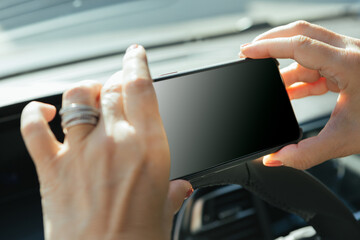 Person taking a photo of mileage on car dashboard for car insurance or damage reporting, empty screen