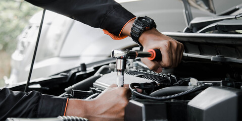 Mechanic fixing a car at home. Repair and service.