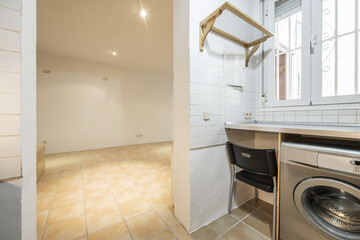 Corner small kitchen with gray table and matching washing machine