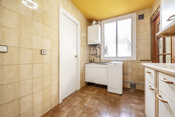 Kitchen with old white wooden cabinets and vintage appliances with matching gas boiler