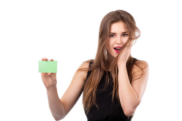 Young pretty caucasian very surprised happy girl holding green credit banking card in her right...