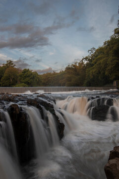 Waterfall in the river flow, Strong water flow between stone rocks