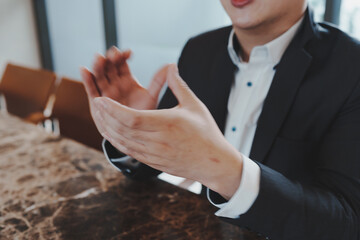 Close up of young business man and digital number of stock market background to represent...