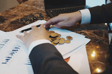 Close up of young business man and digital number of stock market background to represent...