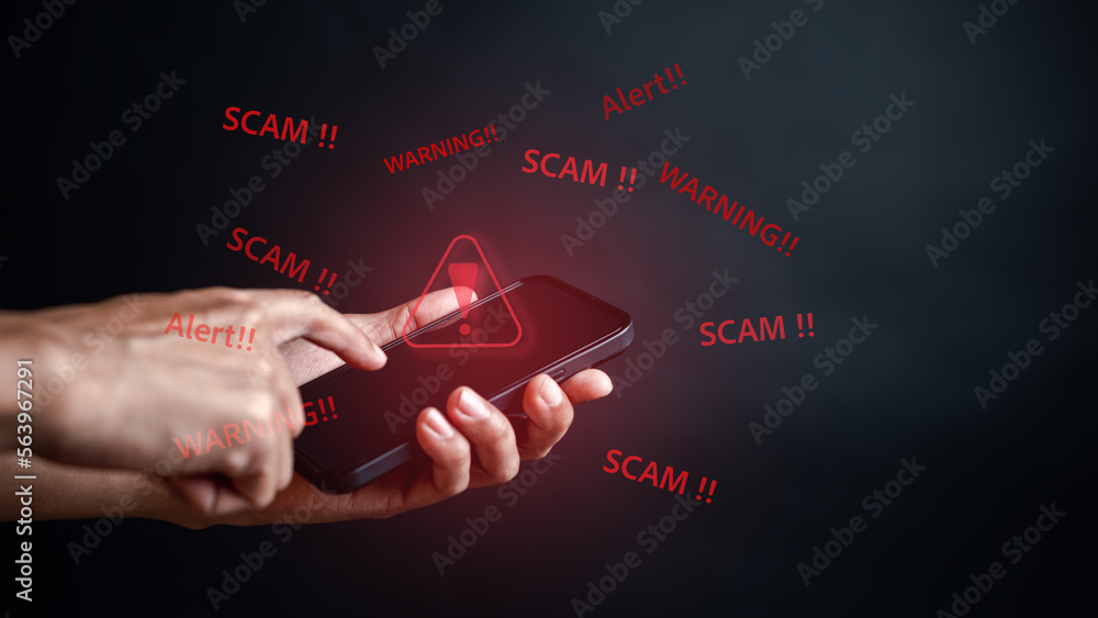 Poster scam alert on notification smartphone concept, virus hacker internet security, businessman holding s
