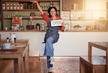 Cafe, woman and open sign in small business, startup and excited while celebrating success with dance. Black woman, coffee shop and business owner hold message, placard or advertising welcome board