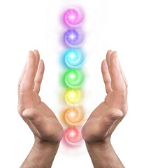 Male Reiki Healer hands palm sides facing inwards with seven rainbow coloured chakra stack in...