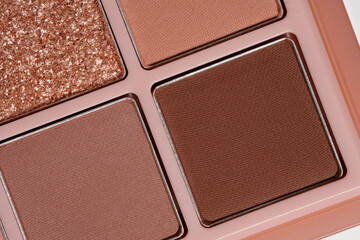 New glitter gold and brown matte eyeshadow macro photo. Cosmetic texture banner background