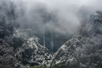 Marmore waterfall covered by the snow and hidden in the fog, Terni, Umbria, Italy