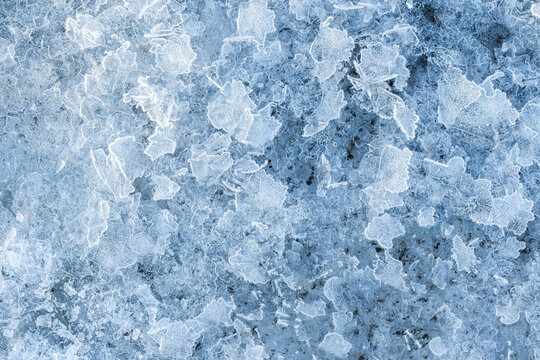 Fragments of thin ice, frozen river surface, macro photo