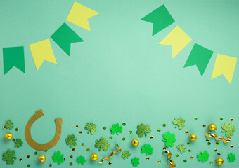 Golden Horseshoe, Gold Coins and Clover Leaves Shamrocks on Green Mint Background.