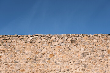 old stone wall with sky