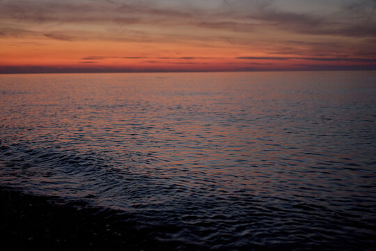 red sunrise over calm blue sea