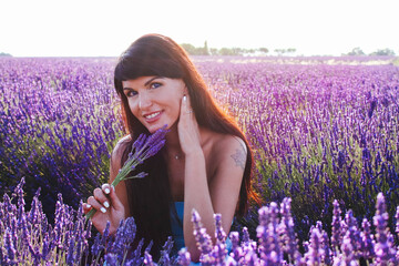 Young woman posing in lavender field on a sunny day, Provence