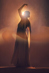 Fantasy, orange lighting and silhouette of woman on stage for creative fashion, art deco and...