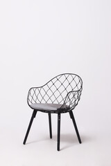 mesh black metal chair with white seamless background