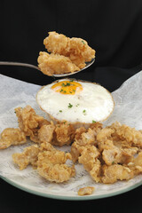 full spoon salted egg fried chicken with sunny side up